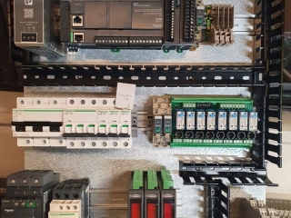 An intricate close-up view of a complex electrical control panel with many wires.