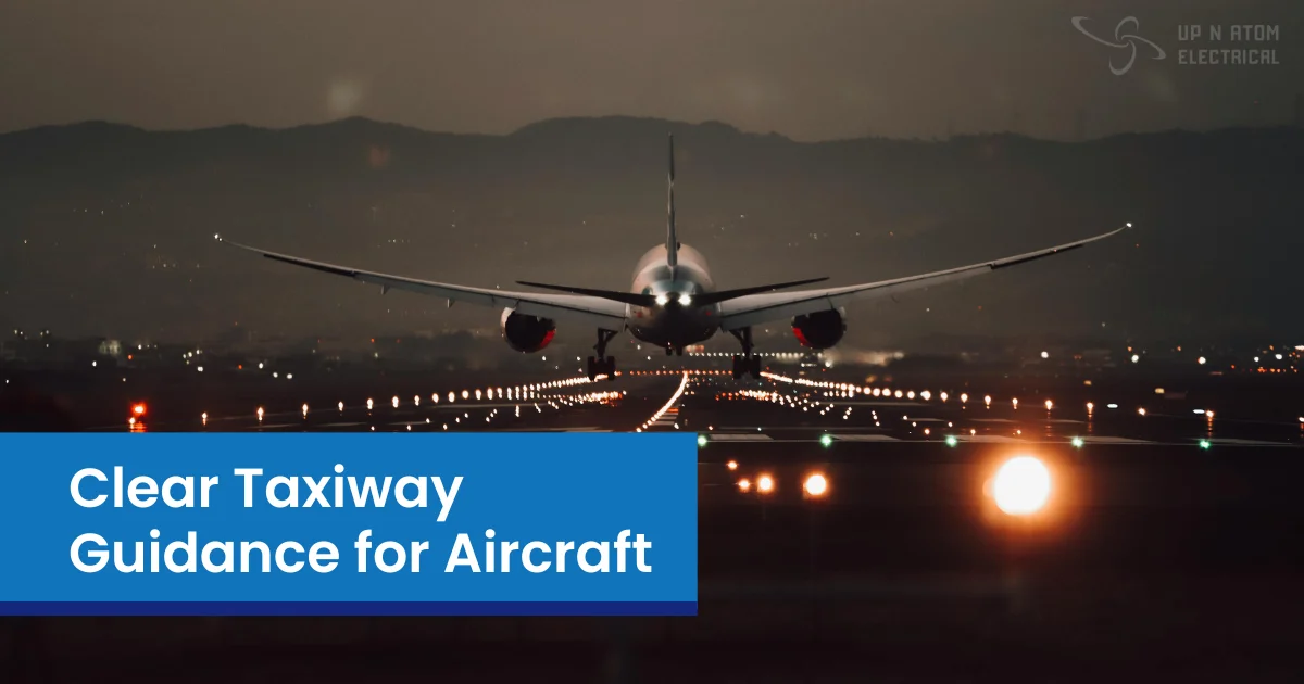 Airplane landing on lit runway at night with visible taxiway lights