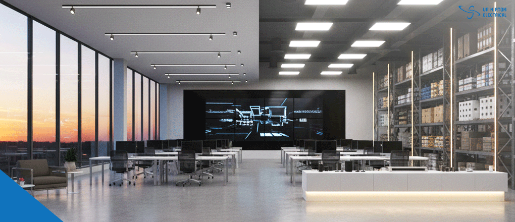 A clean, open-plan office space featuring workstations and floor-to-ceiling windows, illuminated by a modern commercial lighting solution.